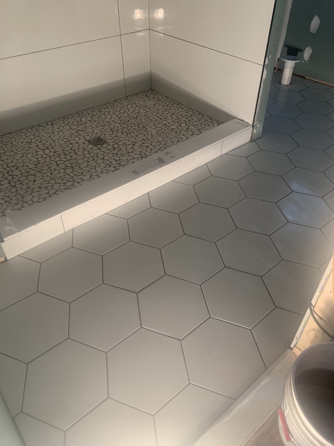 newly remodeled bathroom floors and walls with hexagon white tile