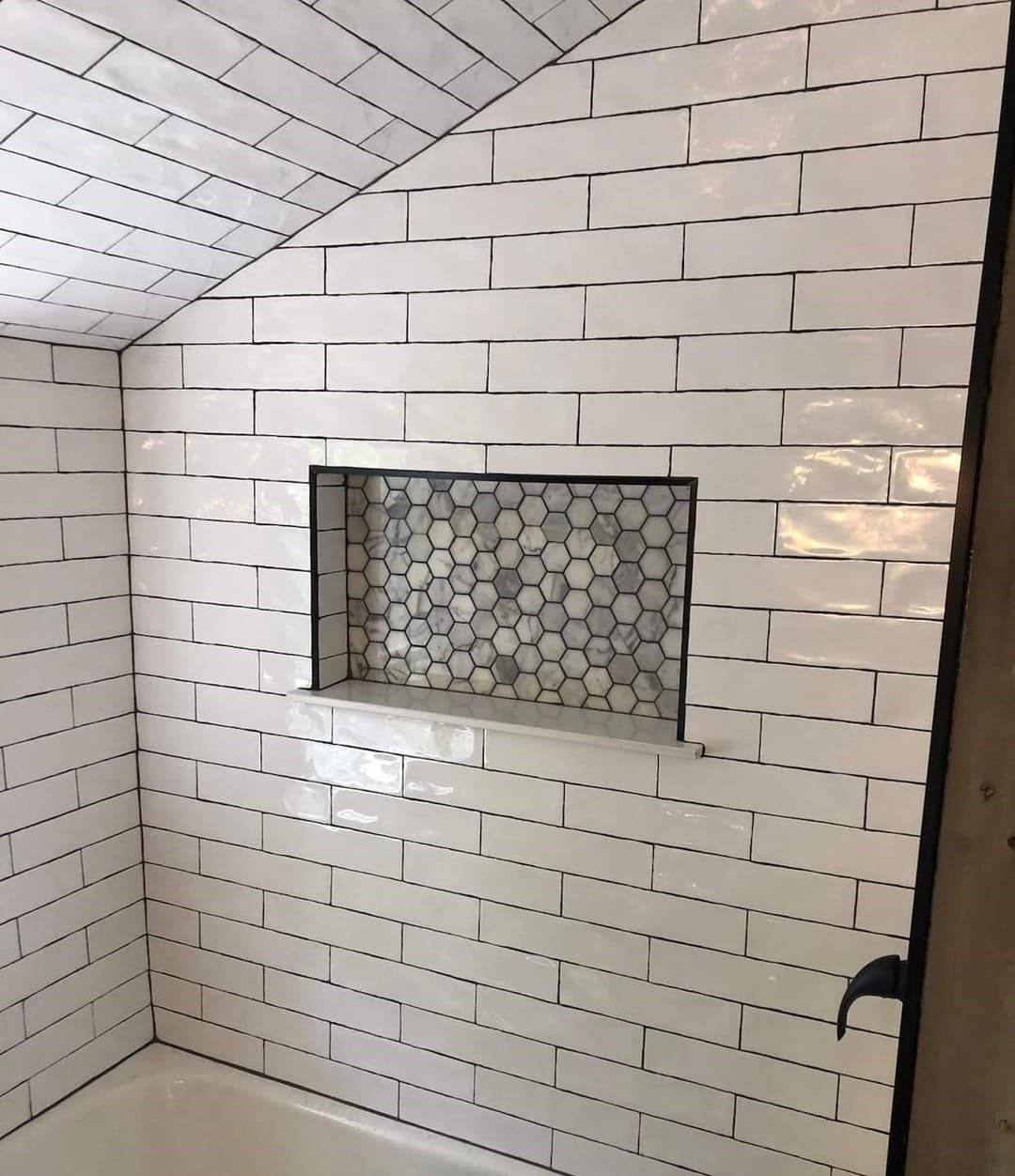 freshly remodeled bathroom with newly installed white rectangular tile