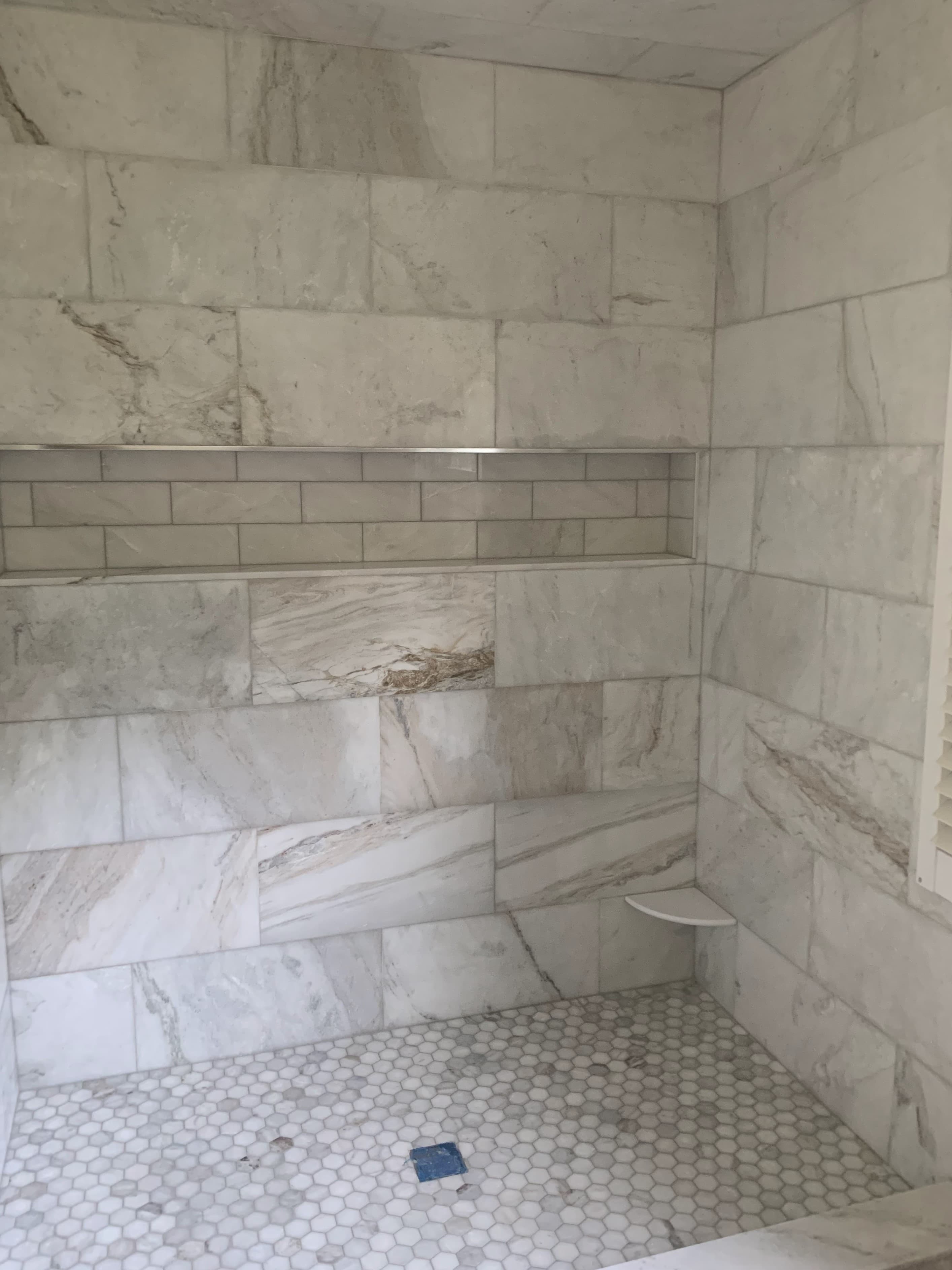 Picture of a newly remodeled bathroom with beautiful tile walls and tile floors 